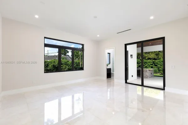 a large white building with kitchen island a sink stainless steel appliances and cabinets
