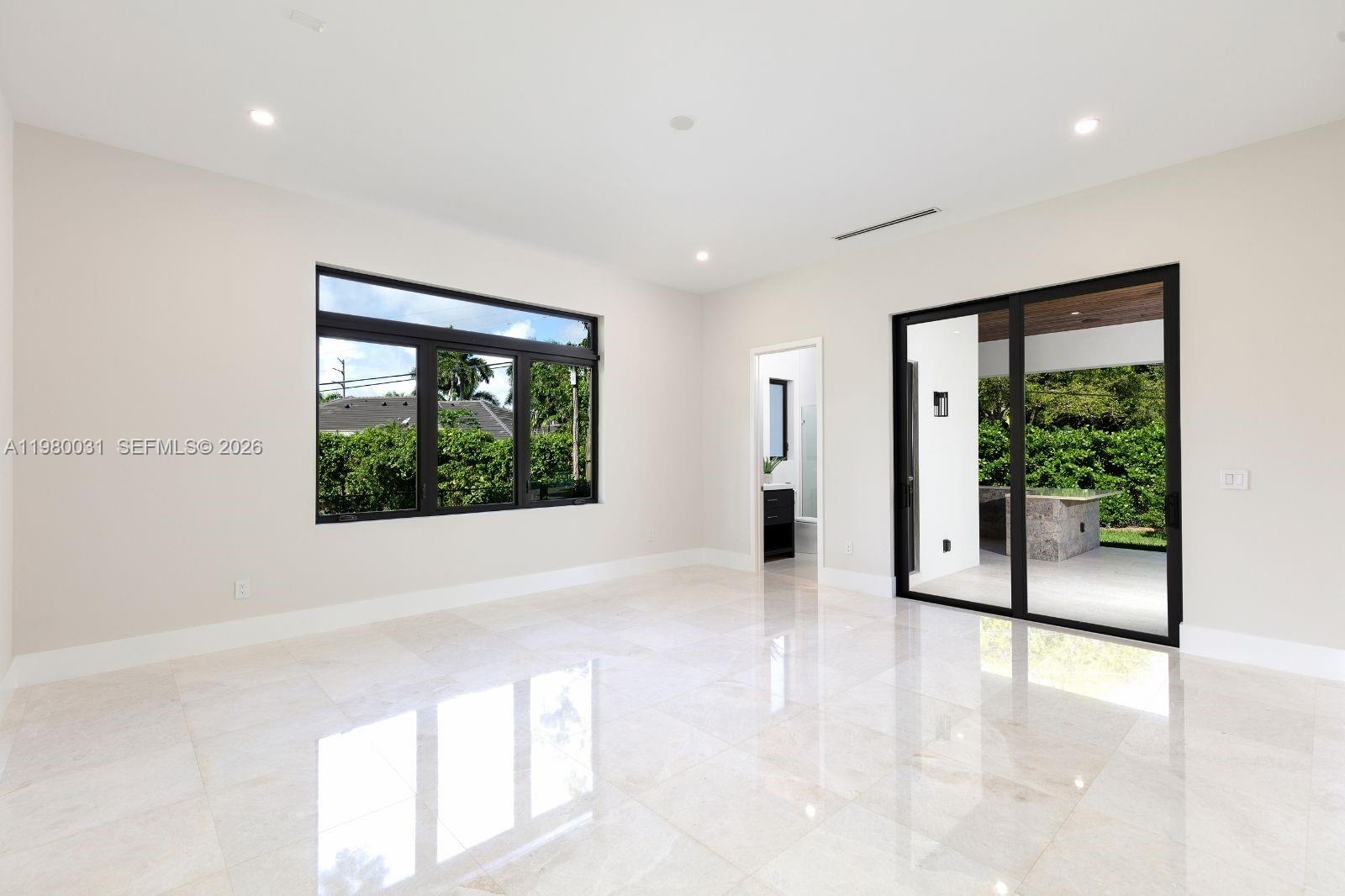 6065 Southwest 109th Street Pinecrest, FL 33156 - Photo 8 of 28 a view of an empty room with a window