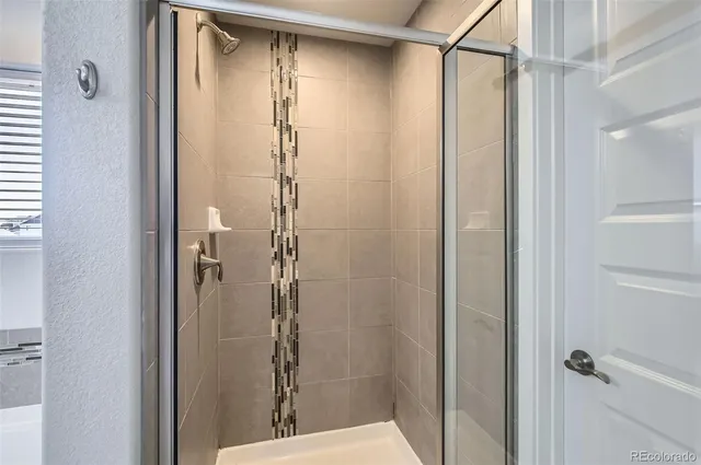 a bathroom with a glass shower door
