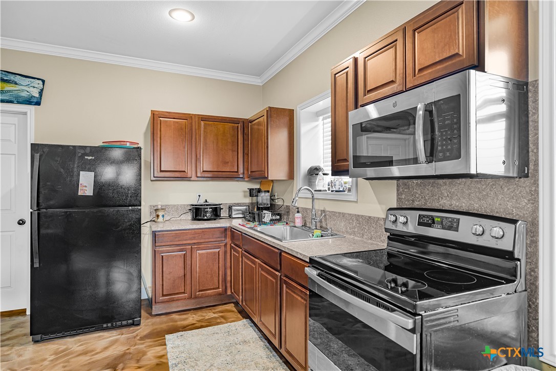 254 Sendera Loop Victoria, TX 77904 - Photo 47 of 48 a kitchen with stainless steel appliances granite countertop a stove a refrigerator and a stove top oven