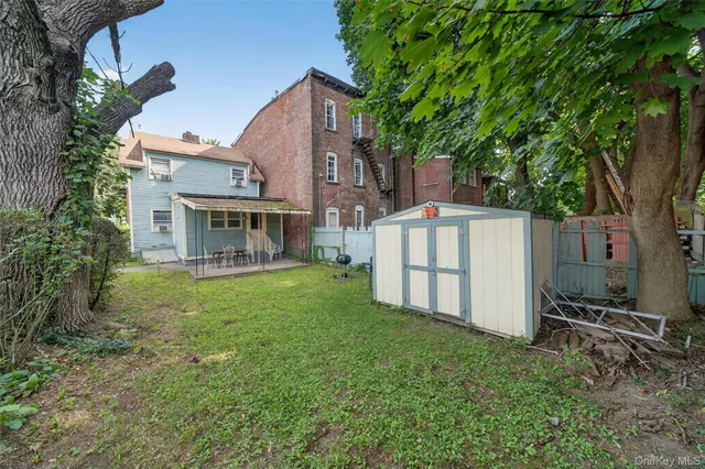 a view of a house with a yard and sitting area
