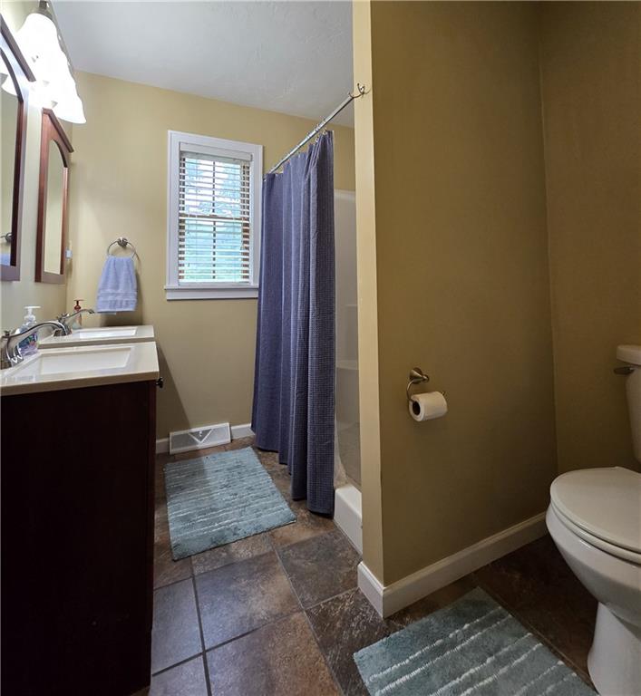 277 Dunn Road Greensburg, PA 15601 - Photo 20 of 24 a bathroom with a sink a toilet a window and vanity