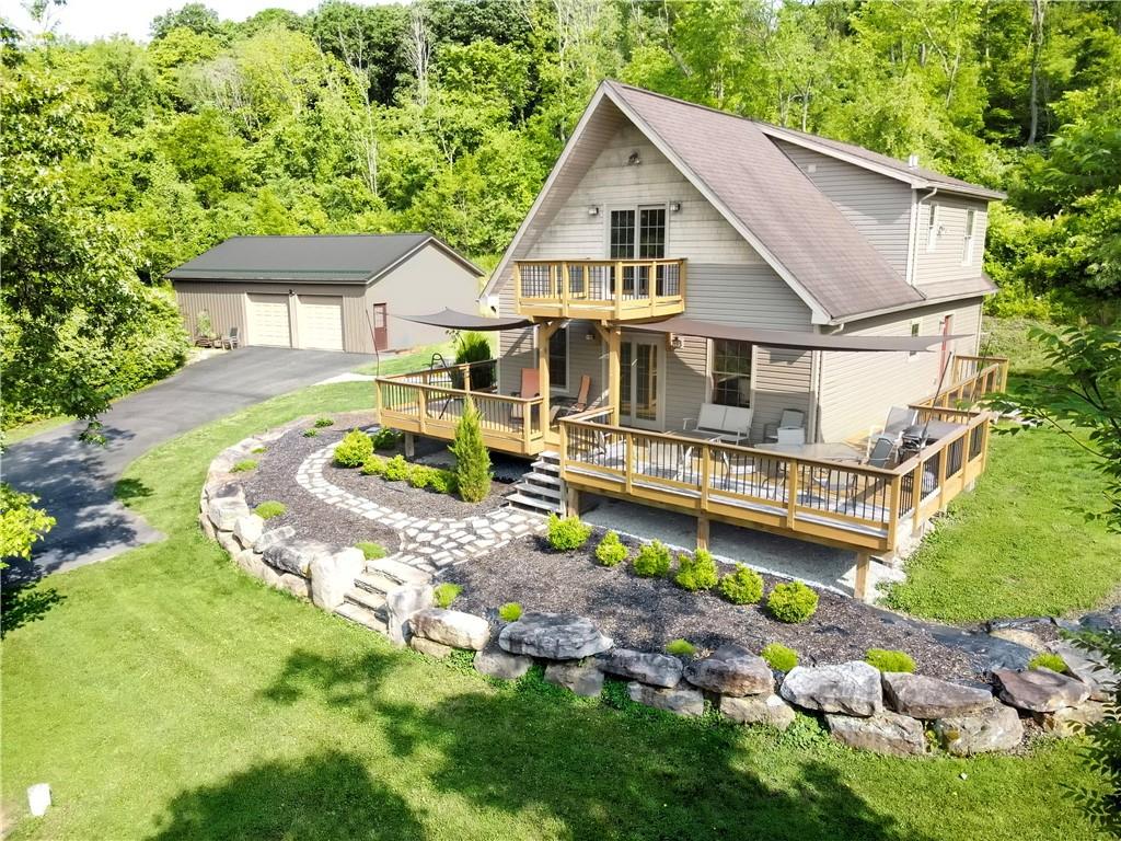 277 Dunn Road Greensburg, PA 15601 - Photo 2 of 24 a view of house with backyard outdoor seating and trees