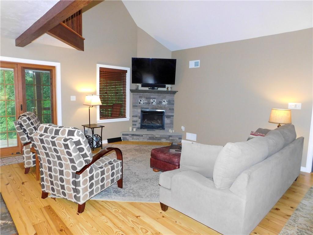 277 Dunn Road Greensburg, PA 15601 - Photo 7 of 24 a living room with furniture a flat screen tv and a fireplace