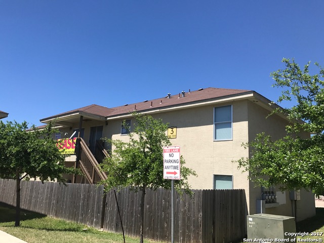 a view of a house with wooden fence