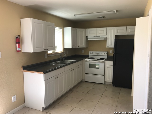 6551 Spring Time Street, Unit 304 San Antonio, TX 78249 - Photo 7 of 9 a kitchen with a sink a stove and refrigerator
