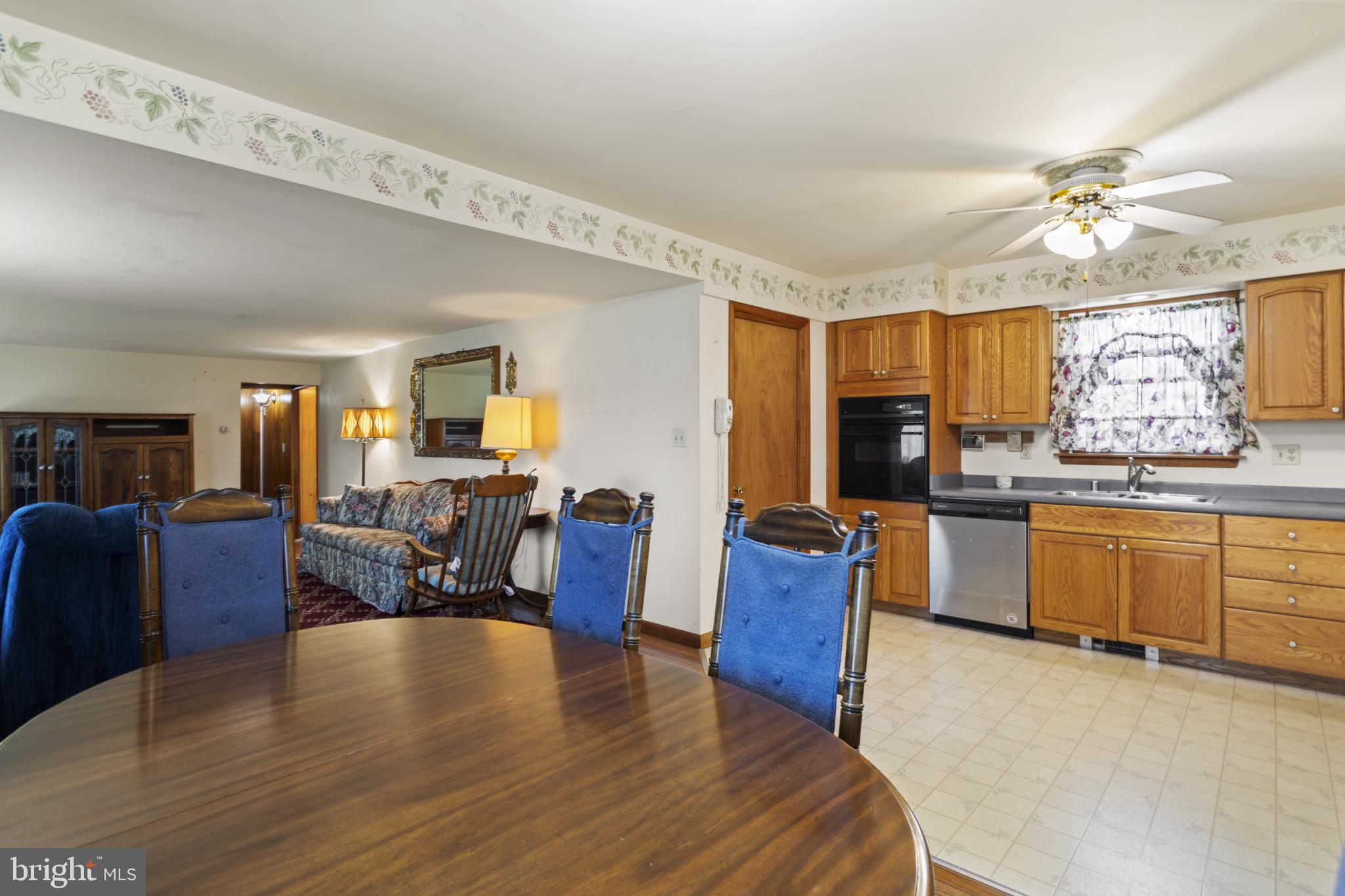 4114 Old Washington Road Westminster, MD 21157 - Photo 11 of 34 a living room with kitchen island granite countertop furniture wooden floor and kitchen view