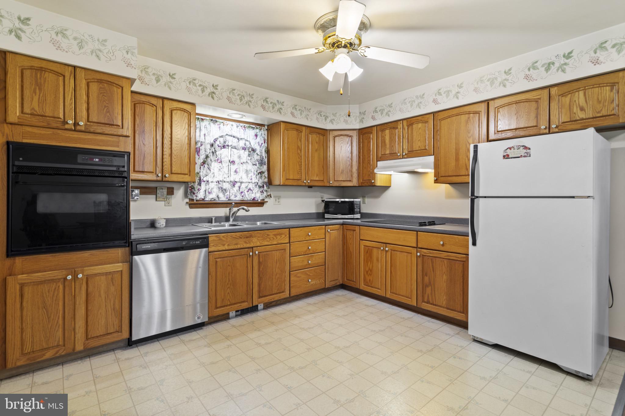 4114 Old Washington Road Westminster, MD 21157 - Photo 12 of 34 a kitchen with granite countertop a refrigerator sink stove and microwave