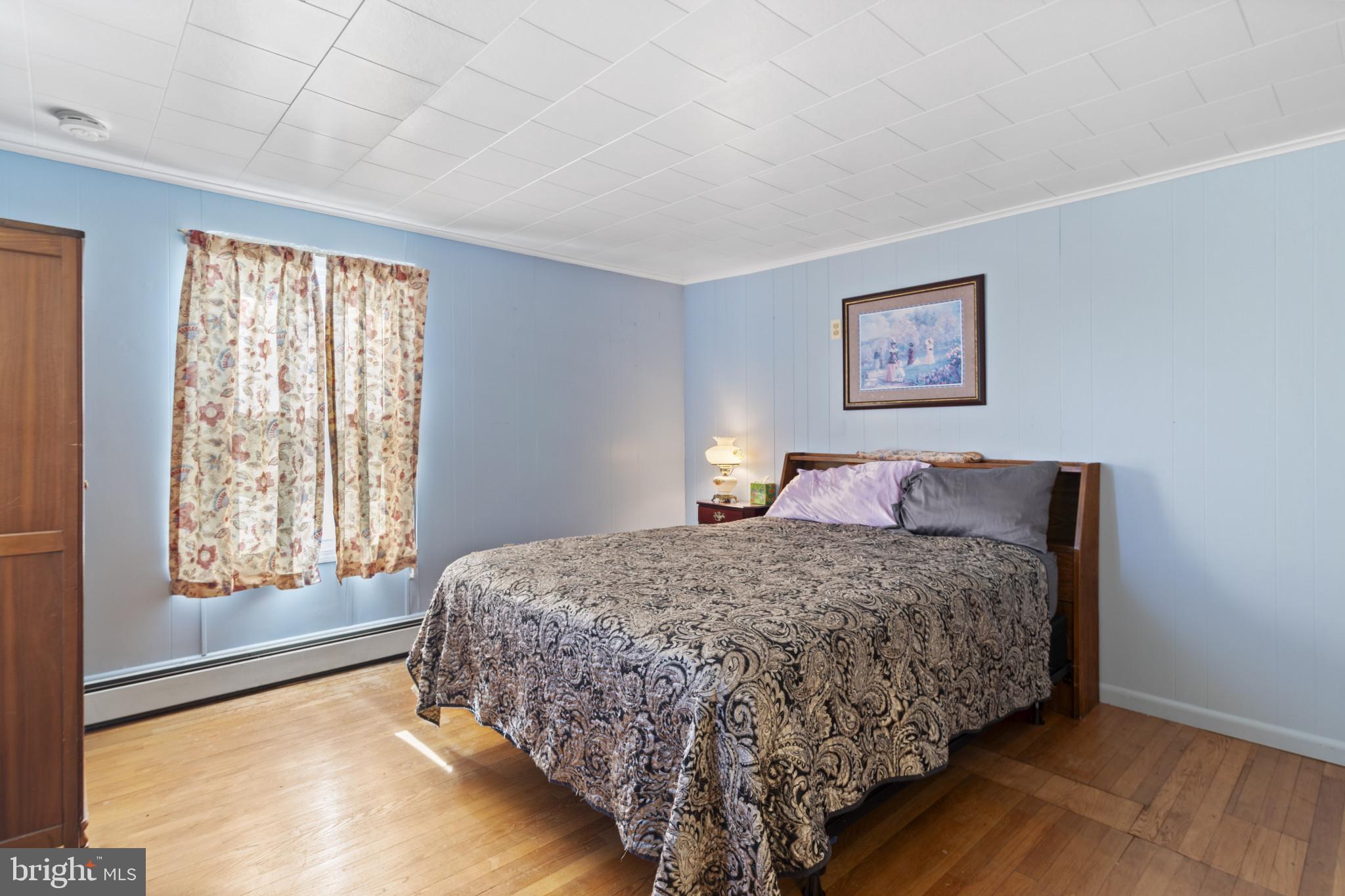 4114 Old Washington Road Westminster, MD 21157 - Photo 19 of 34 a bedroom with a bed and a painting on the wall
