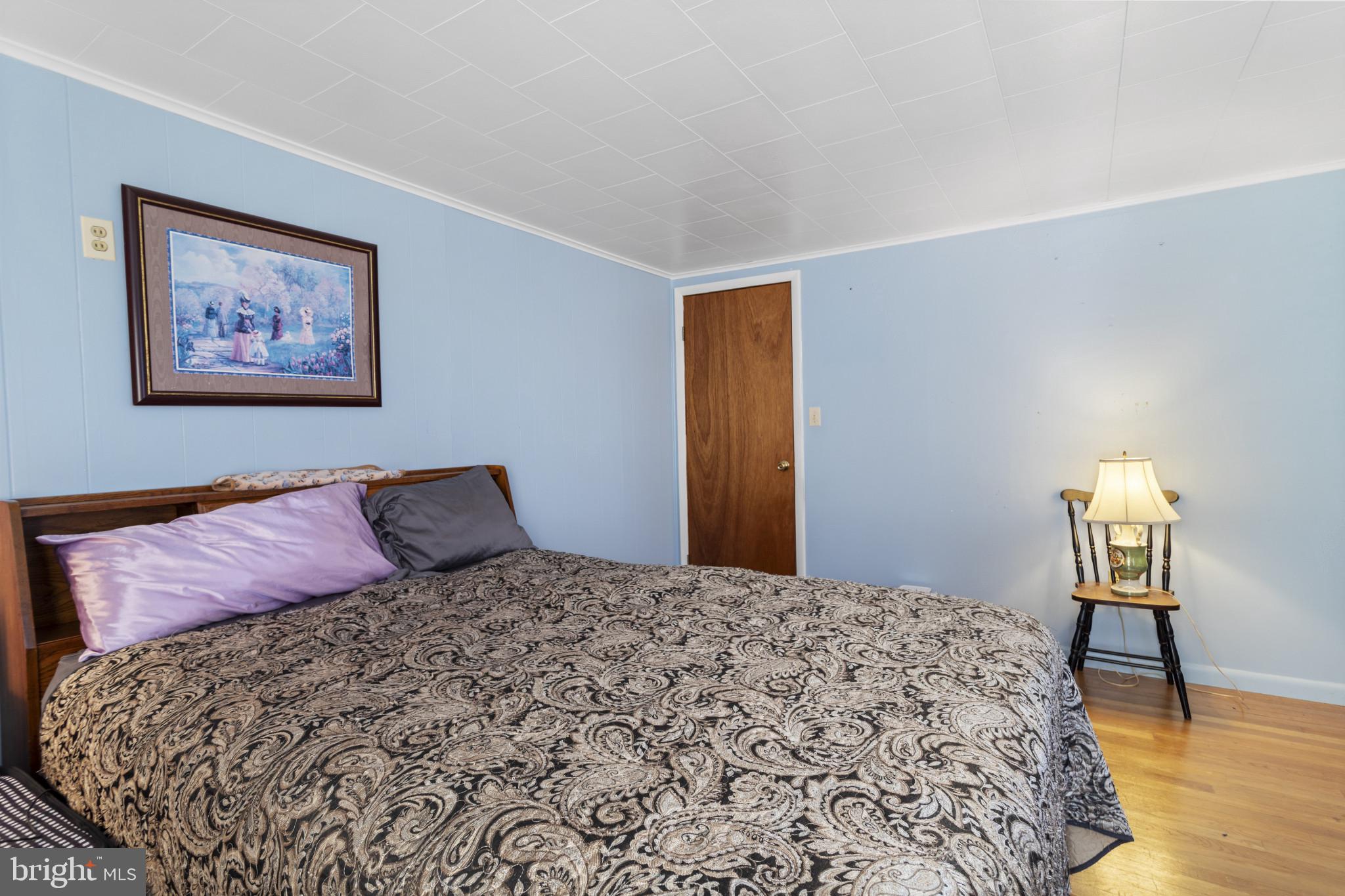 4114 Old Washington Road Westminster, MD 21157 - Photo 20 of 34 a large bed sitting in a bedroom next to a wooden floor