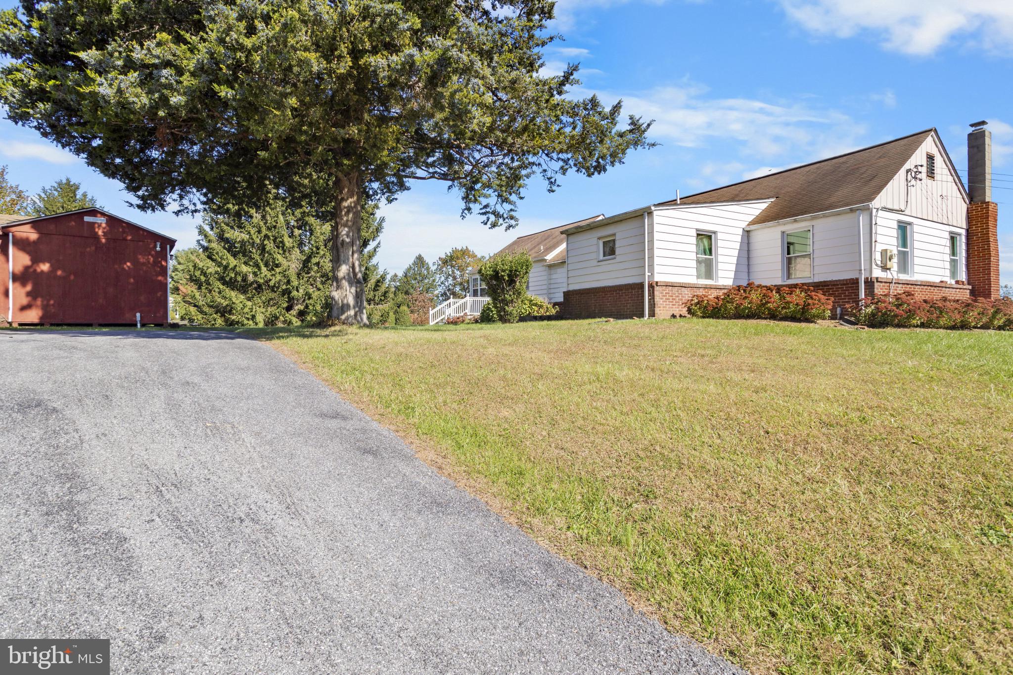 4114 Old Washington Road Westminster, MD 21157 - Photo 6 of 34 a front view of house with yard and trees in the background