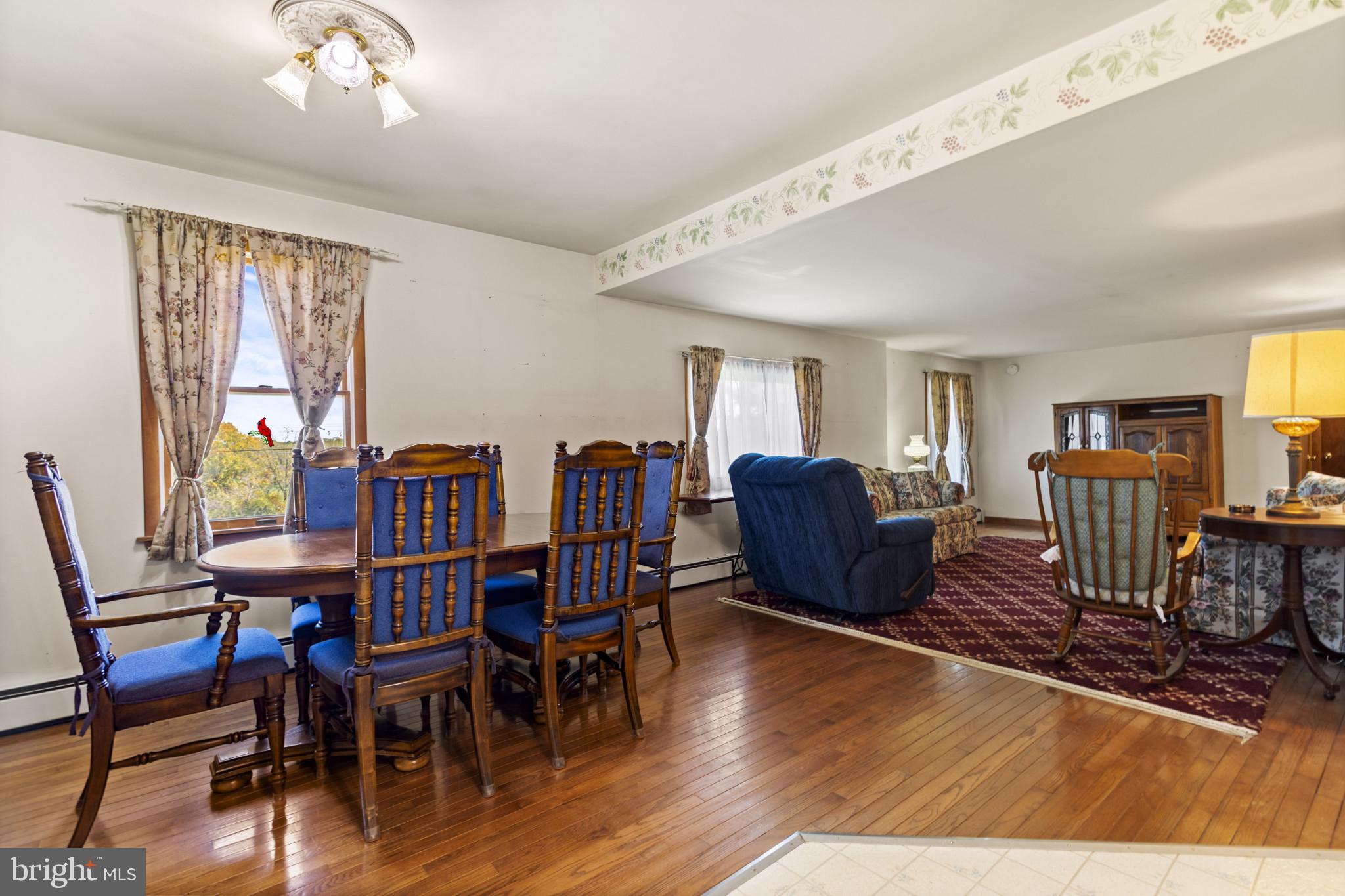 4114 Old Washington Road Westminster, MD 21157 - Photo 10 of 34 a living room with furniture a dining table and a bookshelf with wooden floor