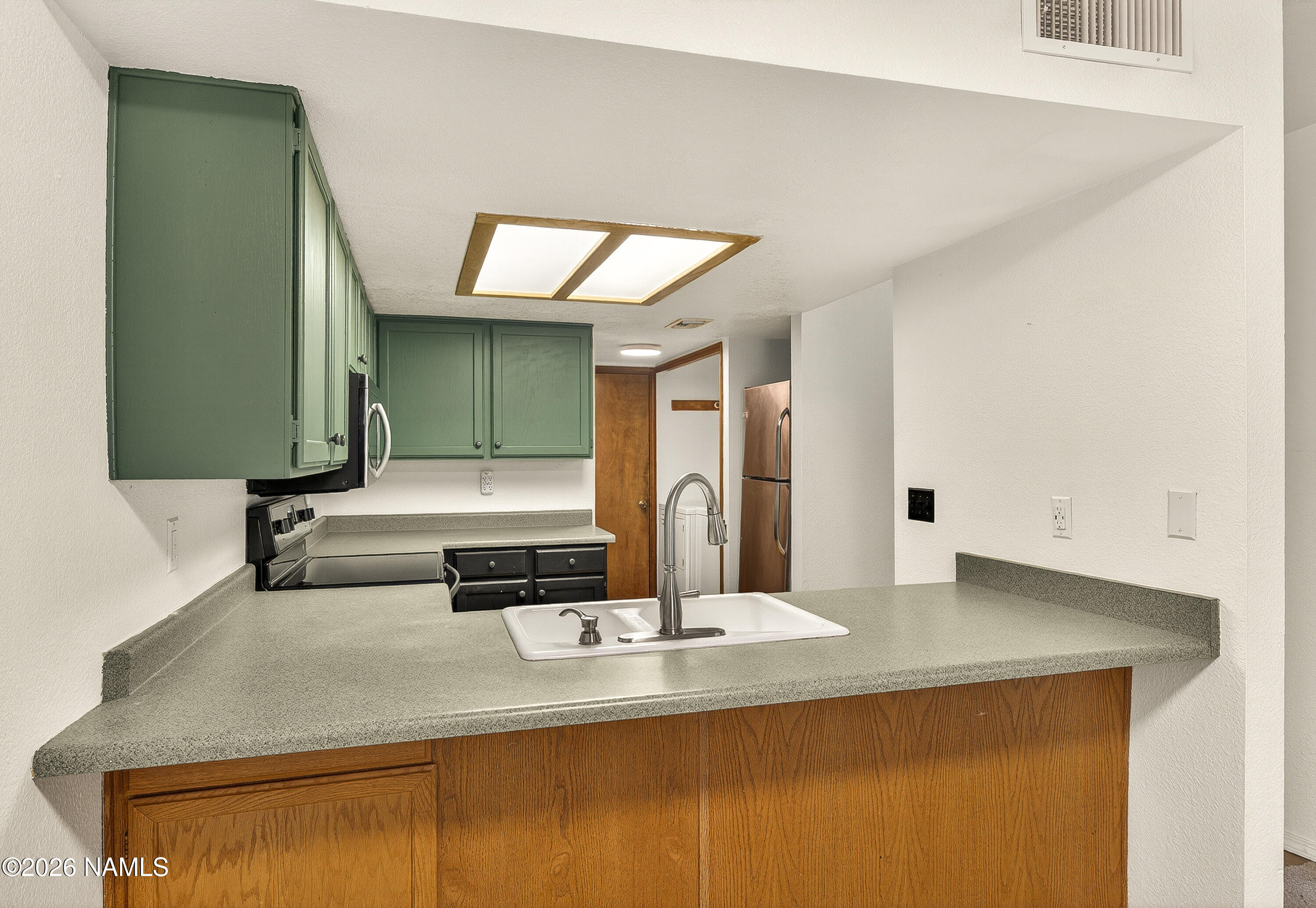 4005 South Lake Mary Road, Unit 9 Flagstaff, AZ 86005 - Photo 11 of 31 a kitchen with kitchen island a sink and a stove