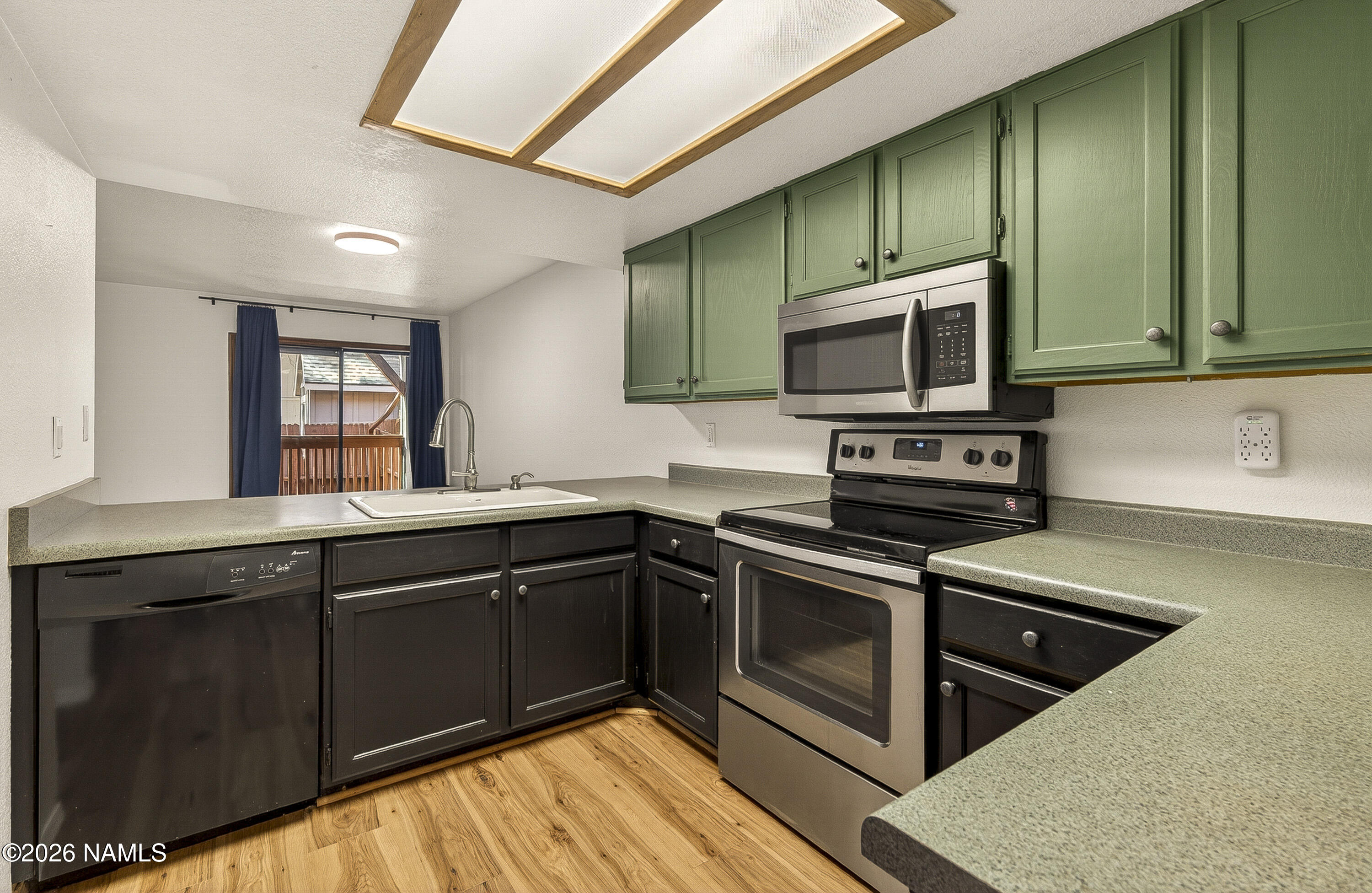 4005 South Lake Mary Road, Unit 9 Flagstaff, AZ 86005 - Photo 12 of 31 a kitchen with stainless steel appliances granite countertop a stove a sink and a microwave