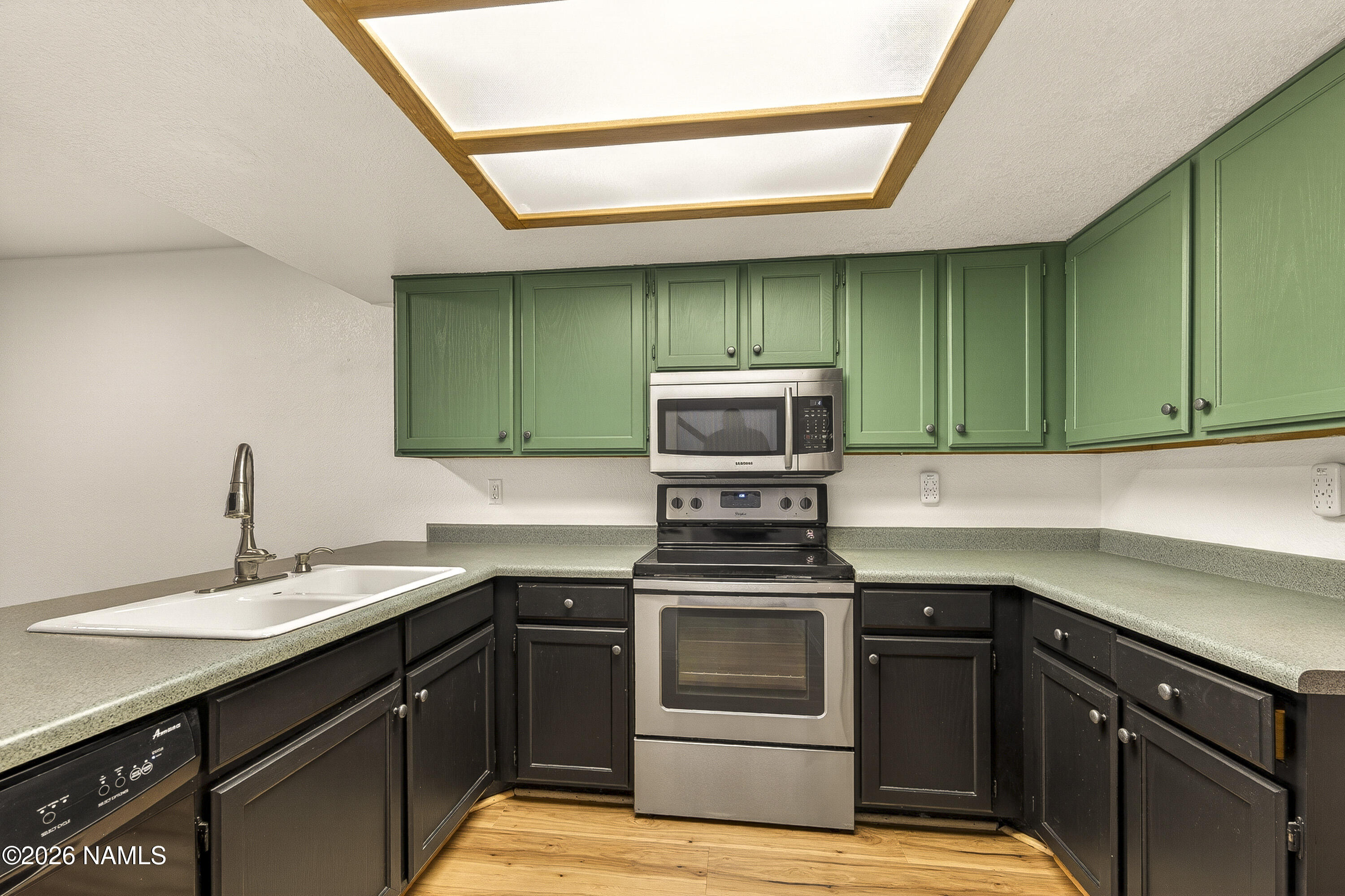 4005 South Lake Mary Road, Unit 9 Flagstaff, AZ 86005 - Photo 13 of 31 a kitchen with a sink a stove and cabinets