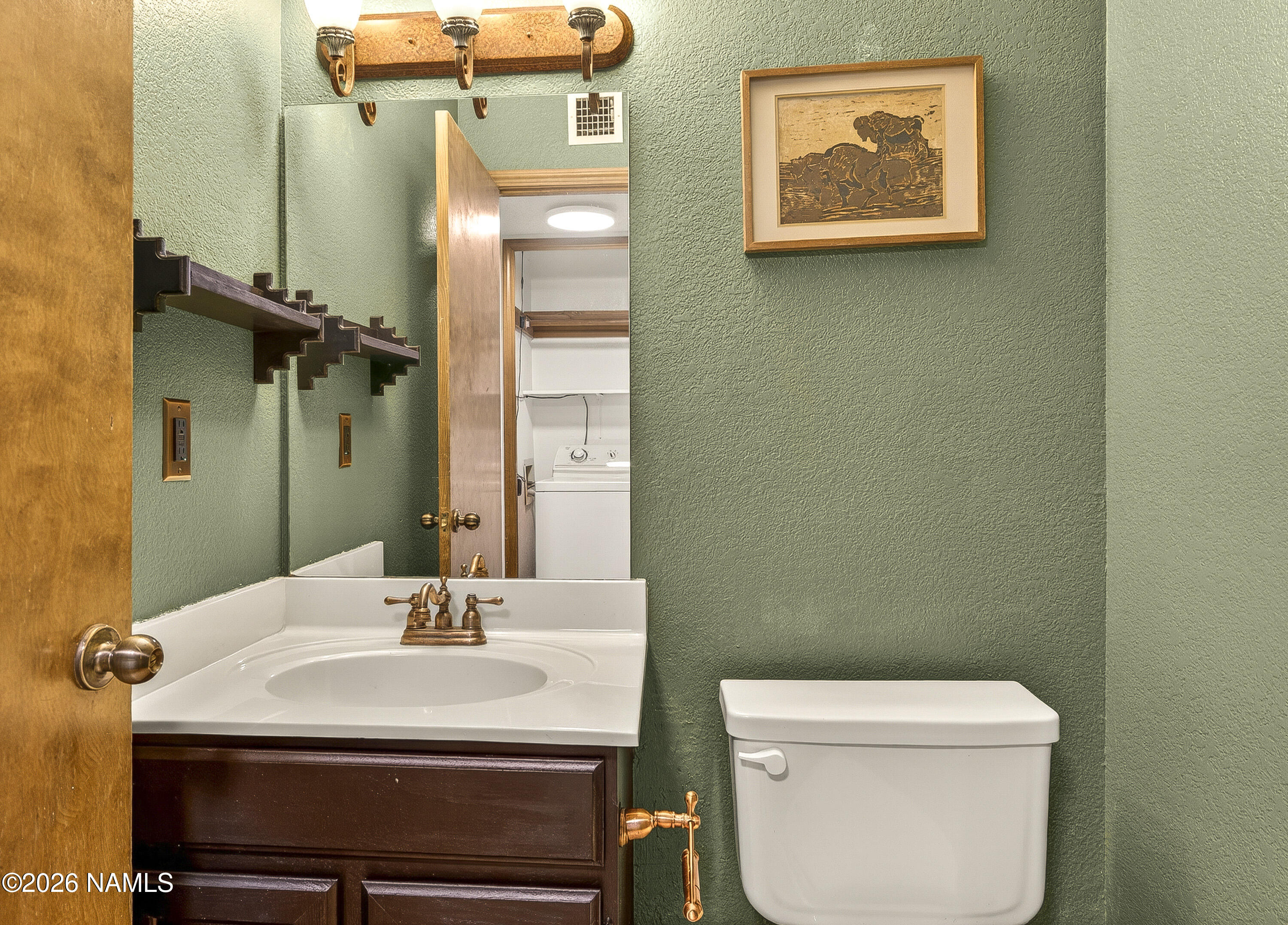 4005 South Lake Mary Road, Unit 9 Flagstaff, AZ 86005 - Photo 16 of 31 a bathroom with a toilet a sink and mirror