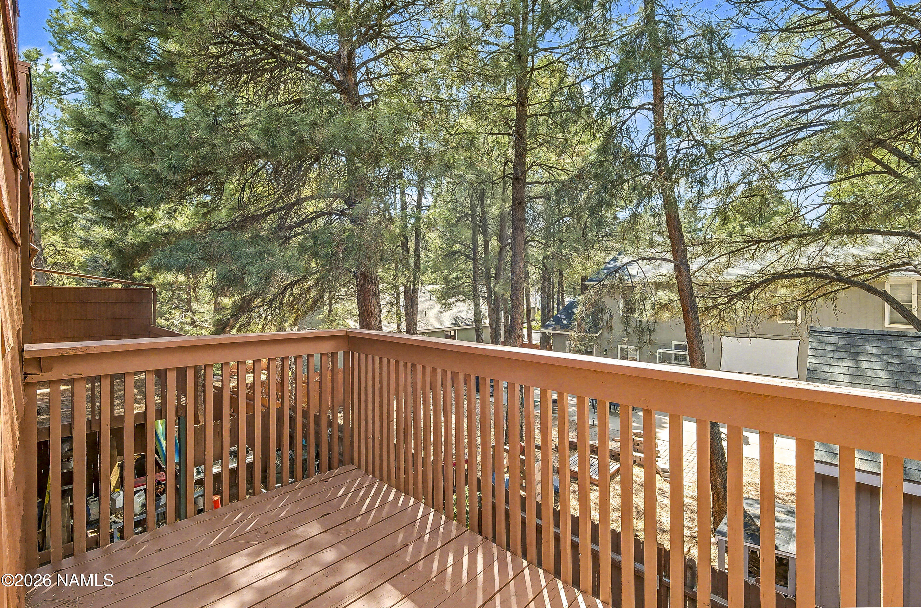 4005 South Lake Mary Road, Unit 9 Flagstaff, AZ 86005 - Photo 20 of 31 a balcony with wooden floor and fence