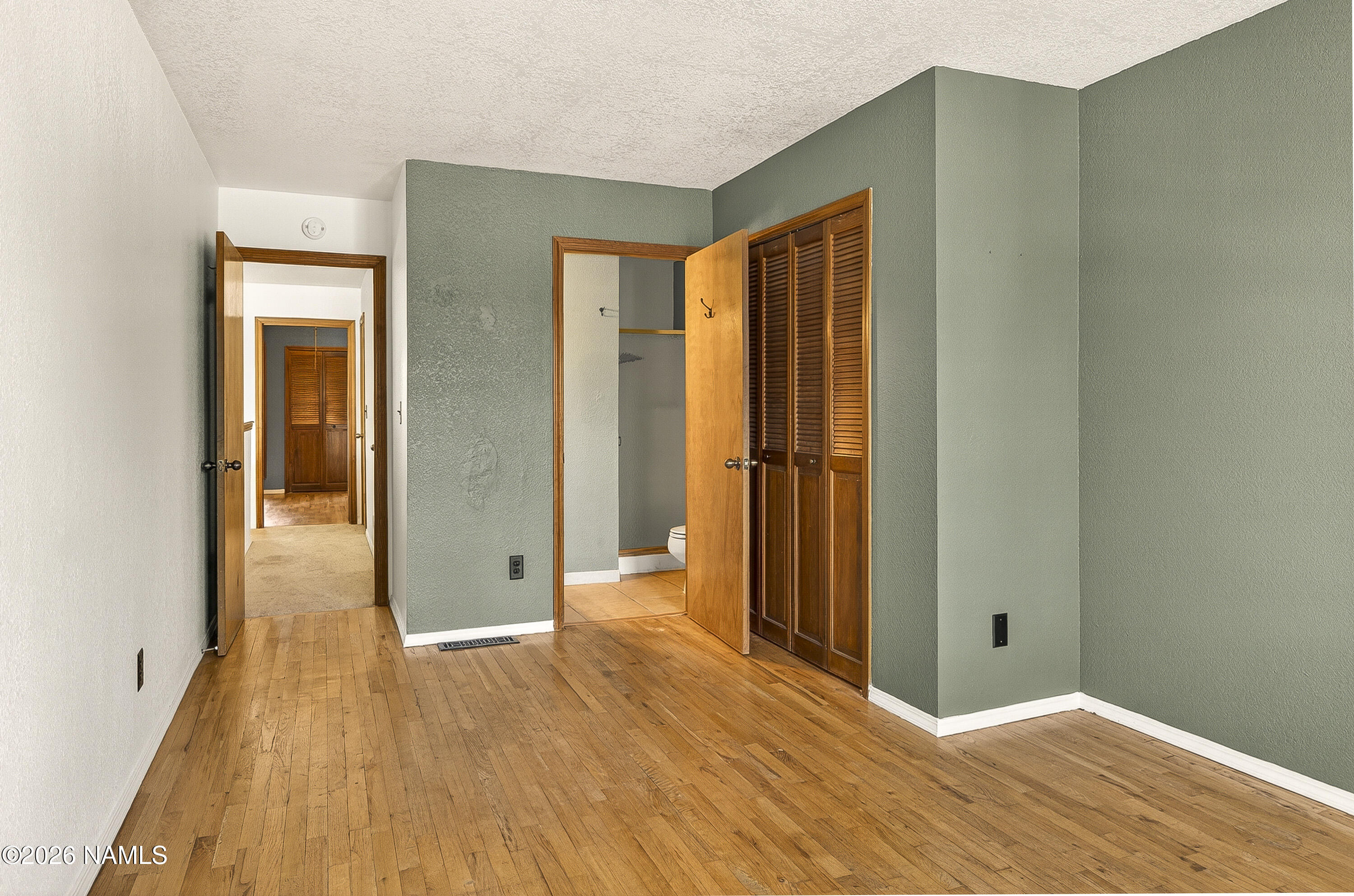 4005 South Lake Mary Road, Unit 9 Flagstaff, AZ 86005 - Photo 26 of 31 a view of a room with wooden floor and brick walls