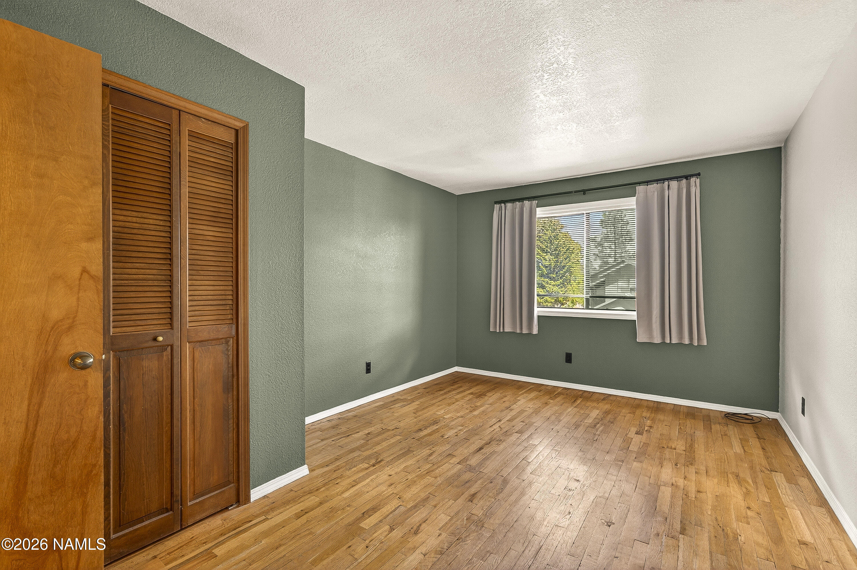 4005 South Lake Mary Road, Unit 9 Flagstaff, AZ 86005 - Photo 27 of 31 a view of empty room with wooden floor and fan