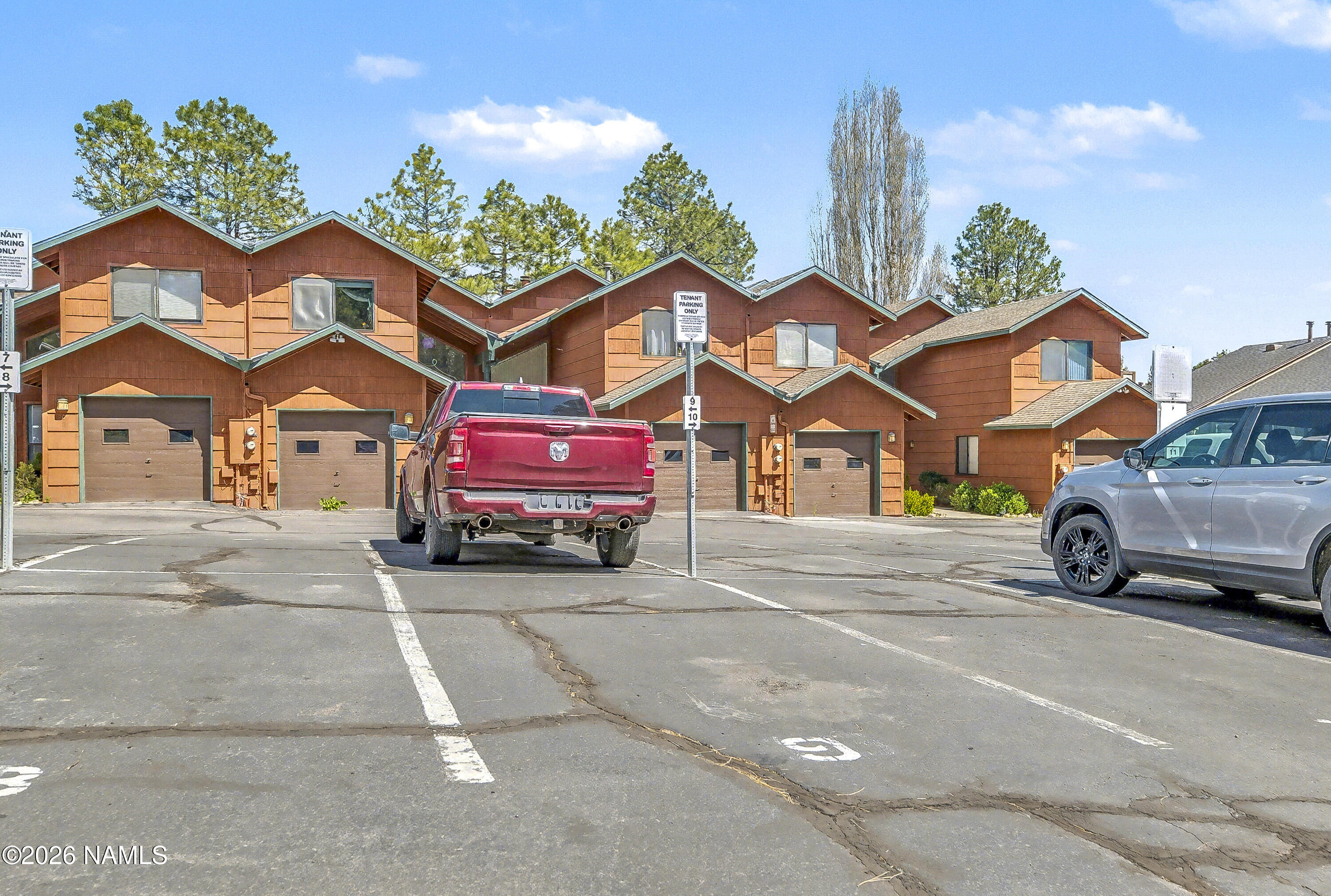 4005 South Lake Mary Road, Unit 9 Flagstaff, AZ 86005 - Photo 30 of 31 a view of a car is parked in front of a brick house