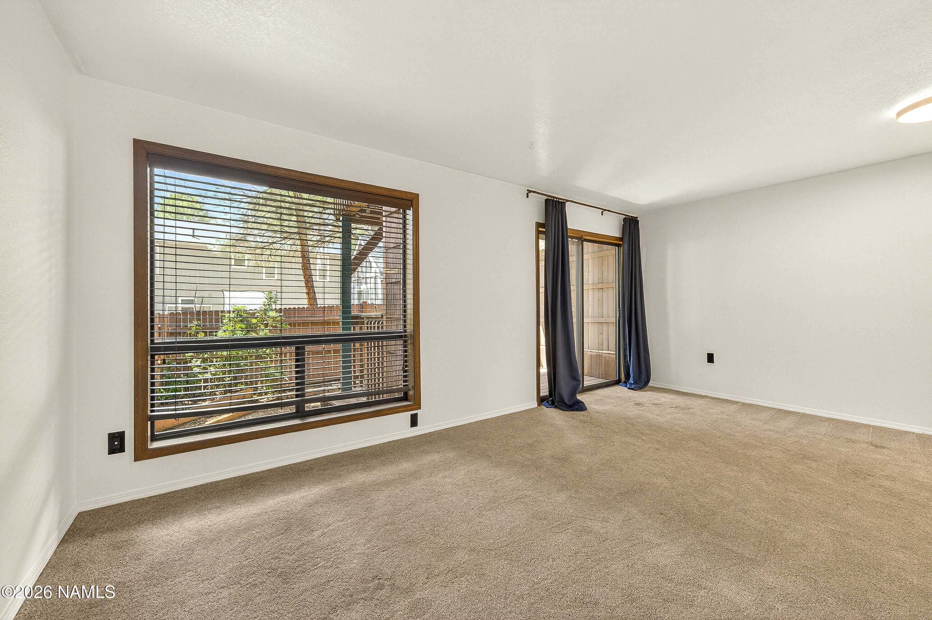4005 South Lake Mary Road, Unit 9 Flagstaff, AZ 86005 - Photo 4 of 31 an empty room with windows