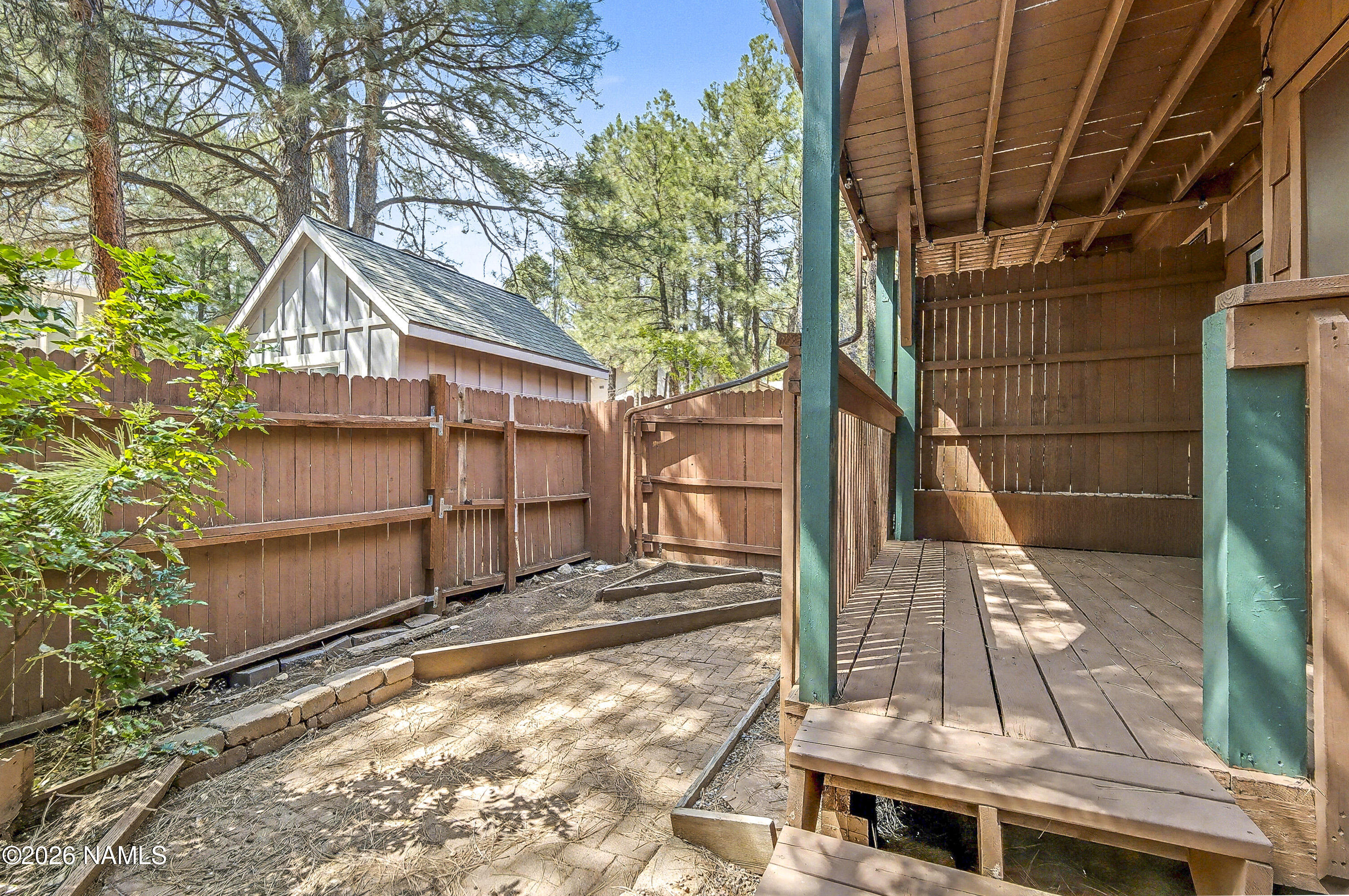 4005 South Lake Mary Road, Unit 9 Flagstaff, AZ 86005 - Photo 7 of 31 a view of a house with a small yard and wooden fence