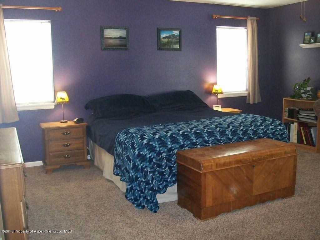 690 Birch Court Rifle, CO 81650 - Photo 11 of 17 a bed sitting in a bedroom next to a window