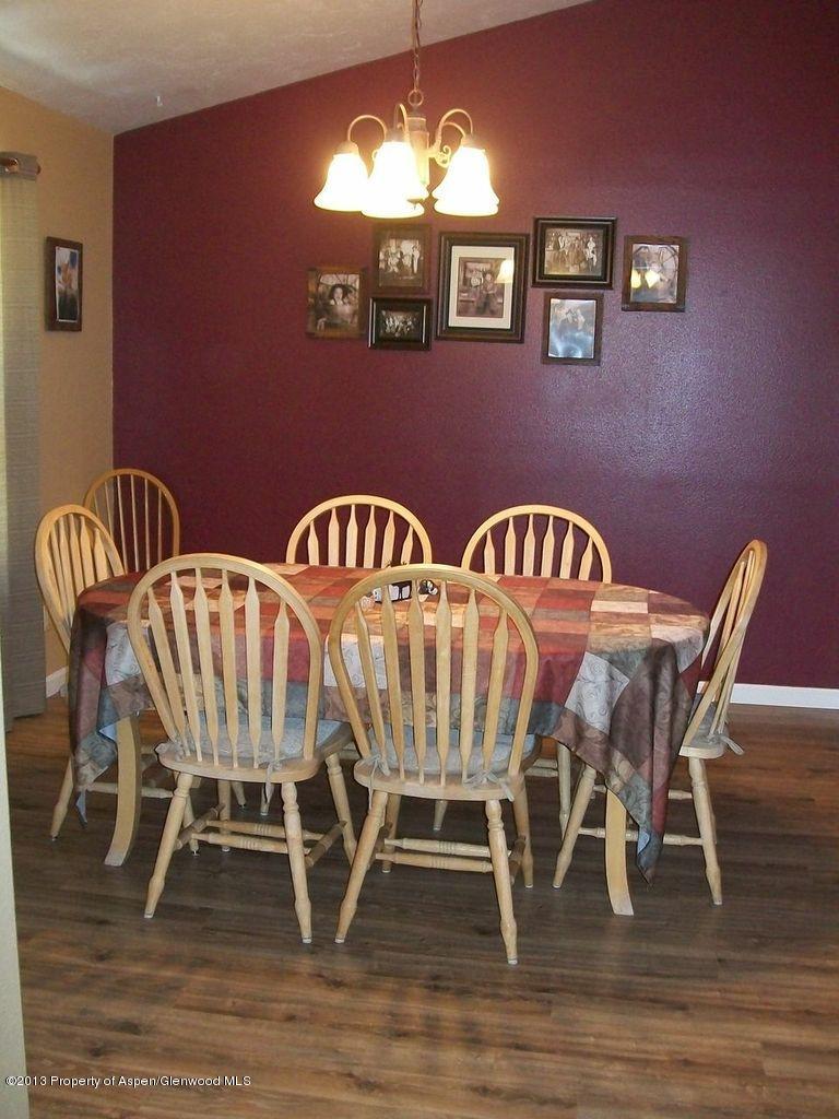 690 Birch Court Rifle, CO 81650 - Photo 8 of 17 a view of a dining room with furniture wooden floor and chandelier