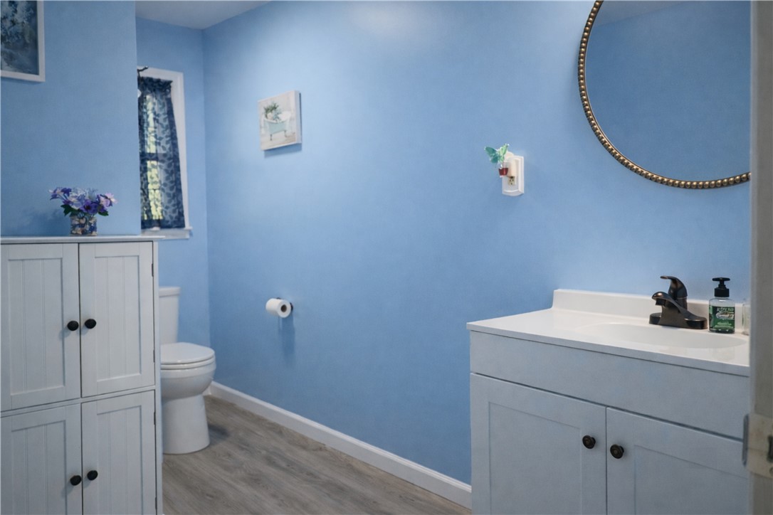 9432 Highway 81 Iva, SC 29655 - Photo 16 of 19 This bathroom features a contemporary vanity and a charming window, providing a bright and functional space.