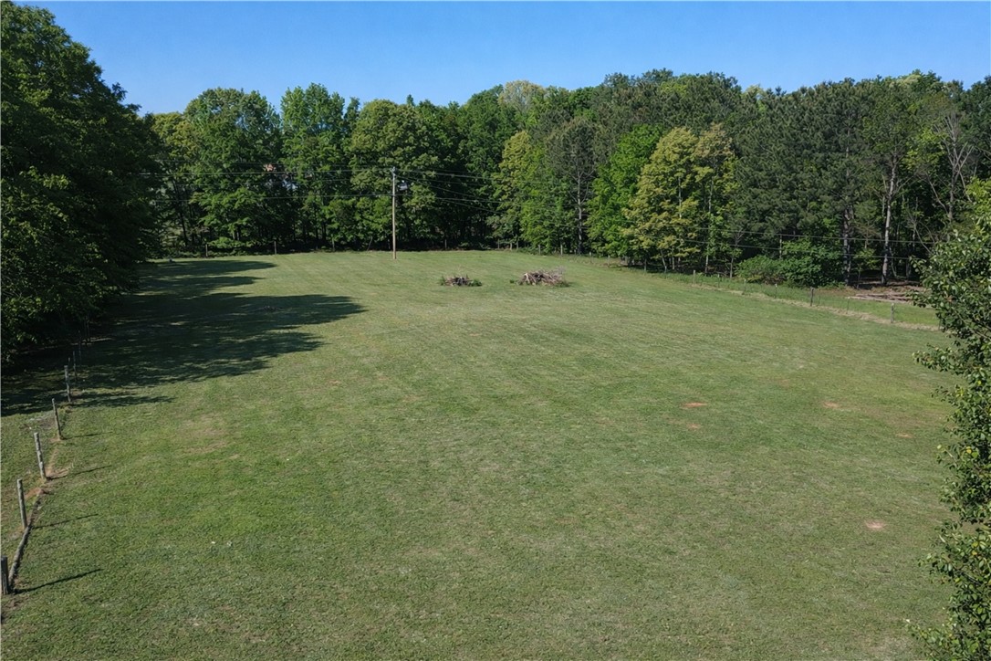 9432 Highway 81 Iva, SC 29655 - Photo 18 of 19 Expansive green acreage bordered by lush trees, perfect for a private estate.