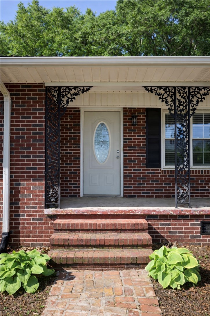 9432 Highway 81 Iva, SC 29655 - Photo 2 of 19 This inviting home features a classic brick exterior with an ornamental railing front porch.