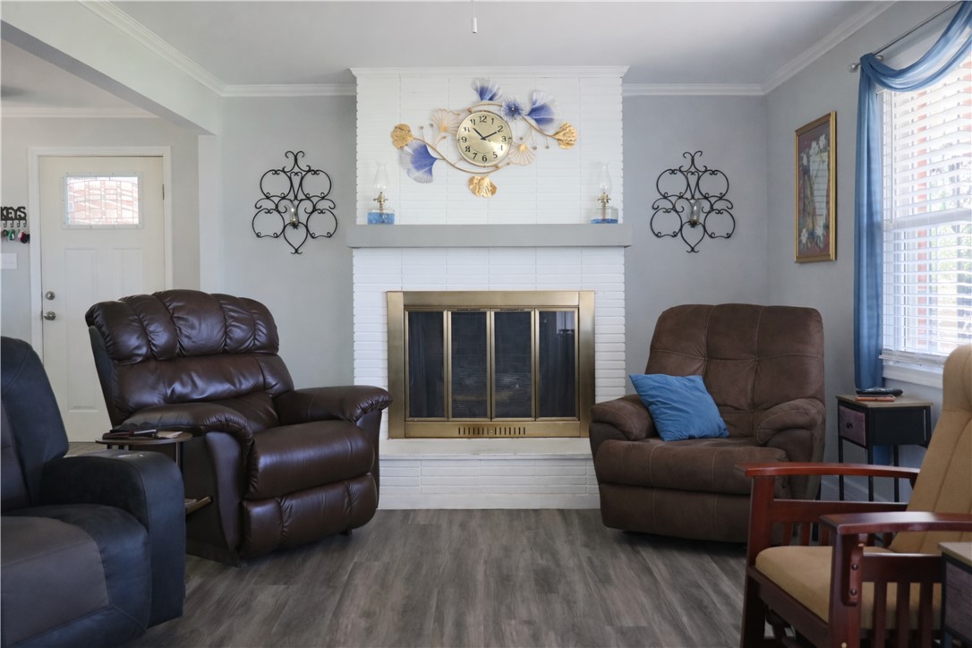 9432 Highway 81 Iva, SC 29655 - Photo 5 of 19 This inviting living space features a cozy fireplace and durable flooring.