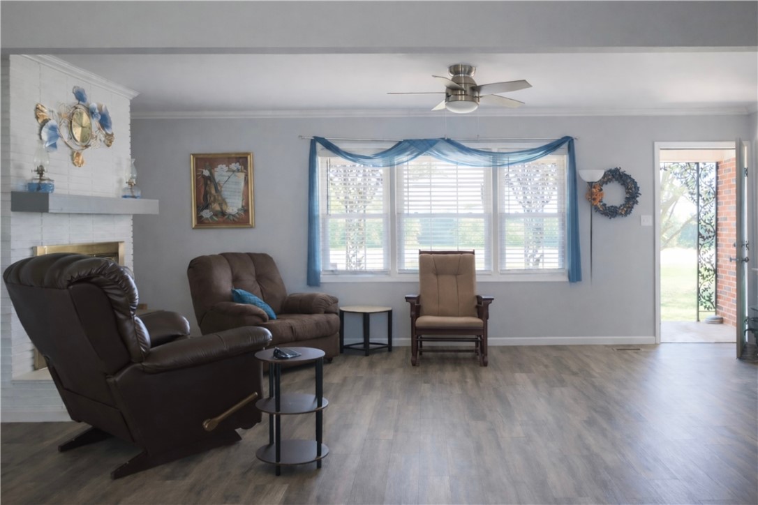 9432 Highway 81 Iva, SC 29655 - Photo 6 of 19 This inviting living space features warm flooring and ample natural light, perfect for everyday living.