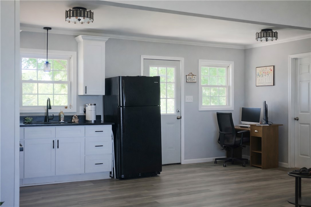 9432 Highway 81 Iva, SC 29655 - Photo 9 of 19 This versatile space seamlessly blends a compact kitchen area with a functional workspace, ideal for modern living.