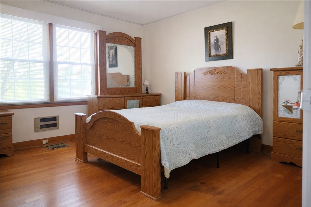9432 Highway 81 Iva, SC 29655 - Photo 10 of 19 This inviting sleeping area showcases warm hardwood floors and ample natural light through large windows.