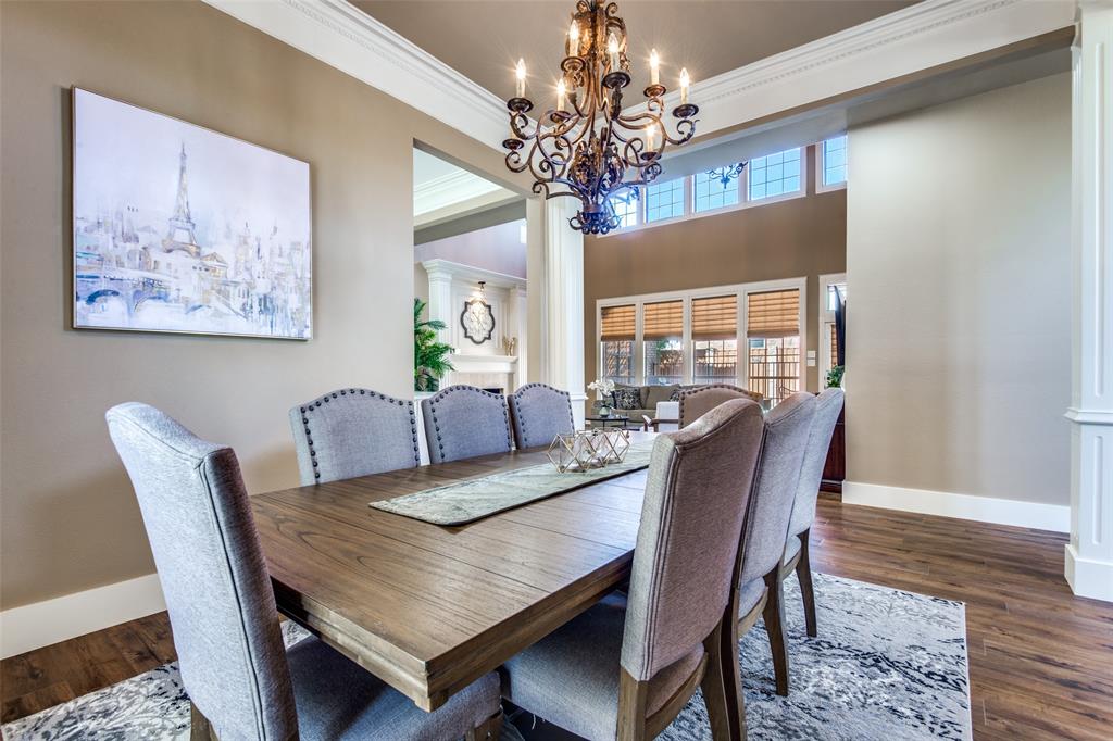 3400 Snidow Drive Plano, TX 75025 - Photo 11 of 25 a view of a dining room with furniture a chandelier and wooden floor