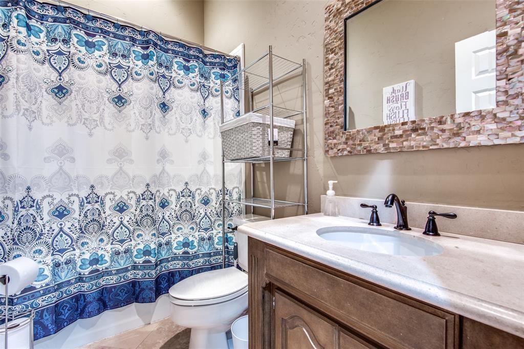 3400 Snidow Drive Plano, TX 75025 - Photo 12 of 25 a bathroom with a granite countertop sink and a toilet
