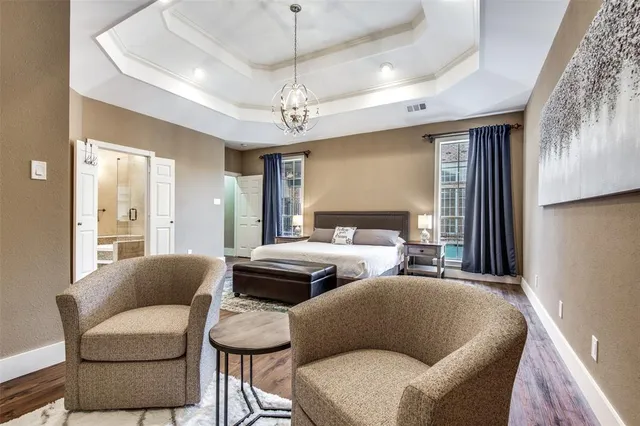 a bedroom with furniture and a chandelier