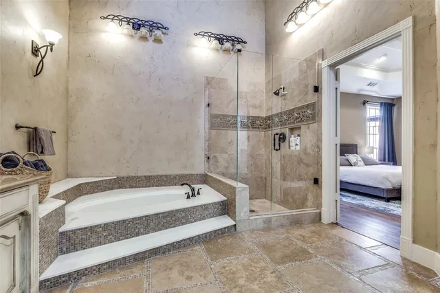 a spacious bathroom with a bathtub and a shower