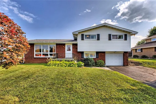 a front view of a house with a garden