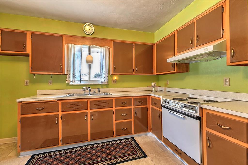 501 Ridgeview Road Mount Pleasant, PA 15666 - Photo 14 of 35 a kitchen with a sink a stove and cabinets