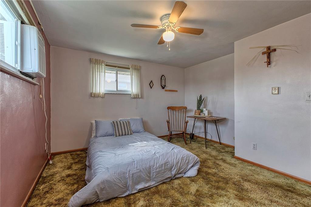 501 Ridgeview Road Mount Pleasant, PA 15666 - Photo 16 of 35 a bedroom with a bed a chandelier and a window