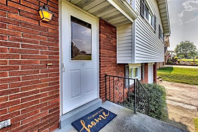 a view of a brick house with a yard