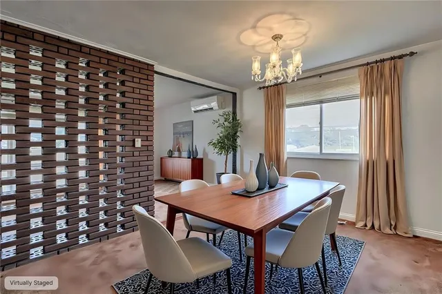 a dining room with furniture and window