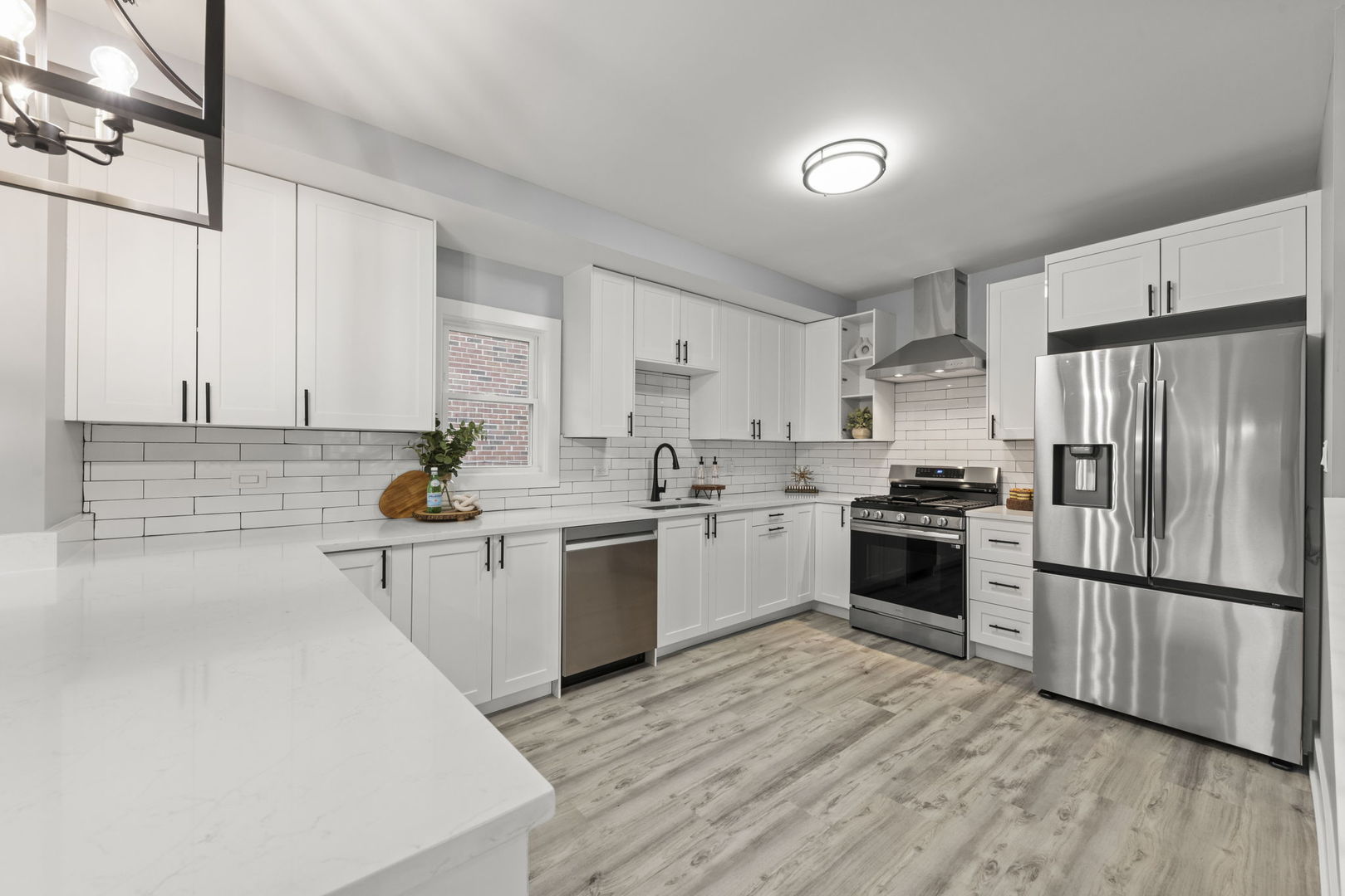 7600 West 60th Street Summit, IL 60501 - Photo 7 of 22 a kitchen with white cabinets and stainless steel appliances