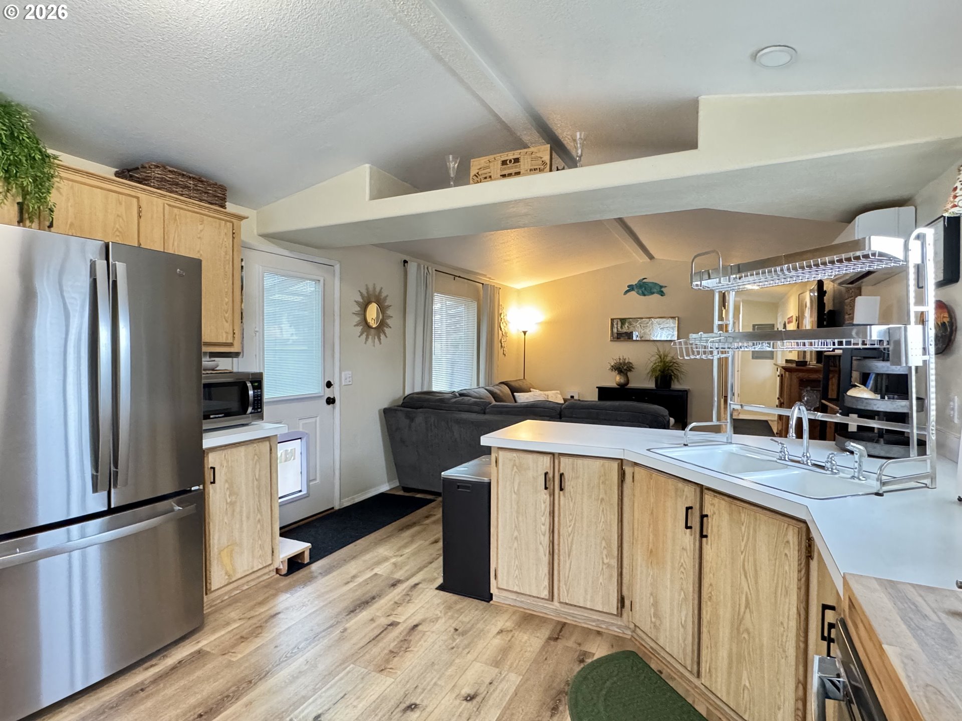 3760 Highway 101, Unit 1 Florence, OR 97439 - Photo 21 of 32 a kitchen with stainless steel appliances granite countertop a sink stove and refrigerator