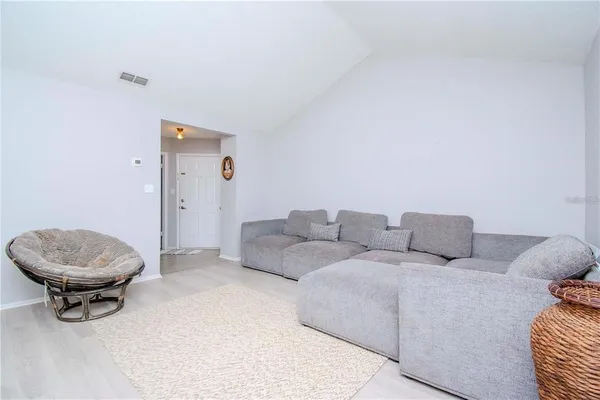 a living room with a couch and a mirror