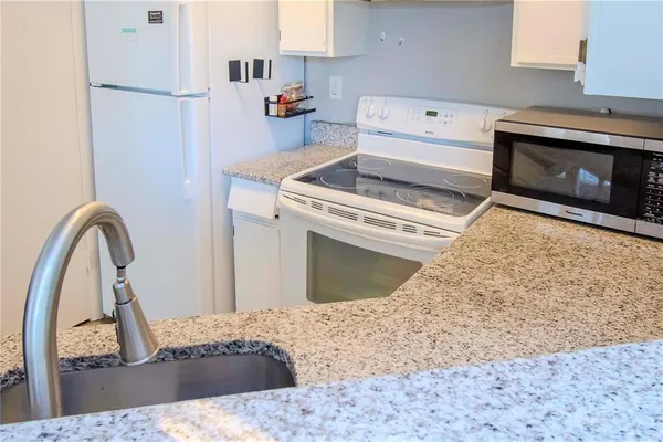 a kitchen with a stove and a microwave