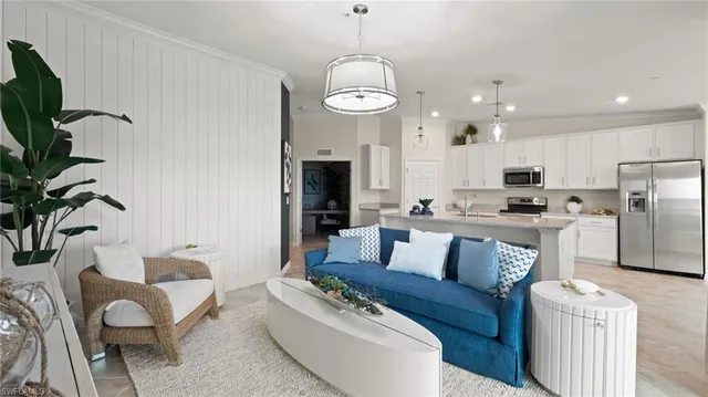 a living room with furniture a potted plant and a fireplace