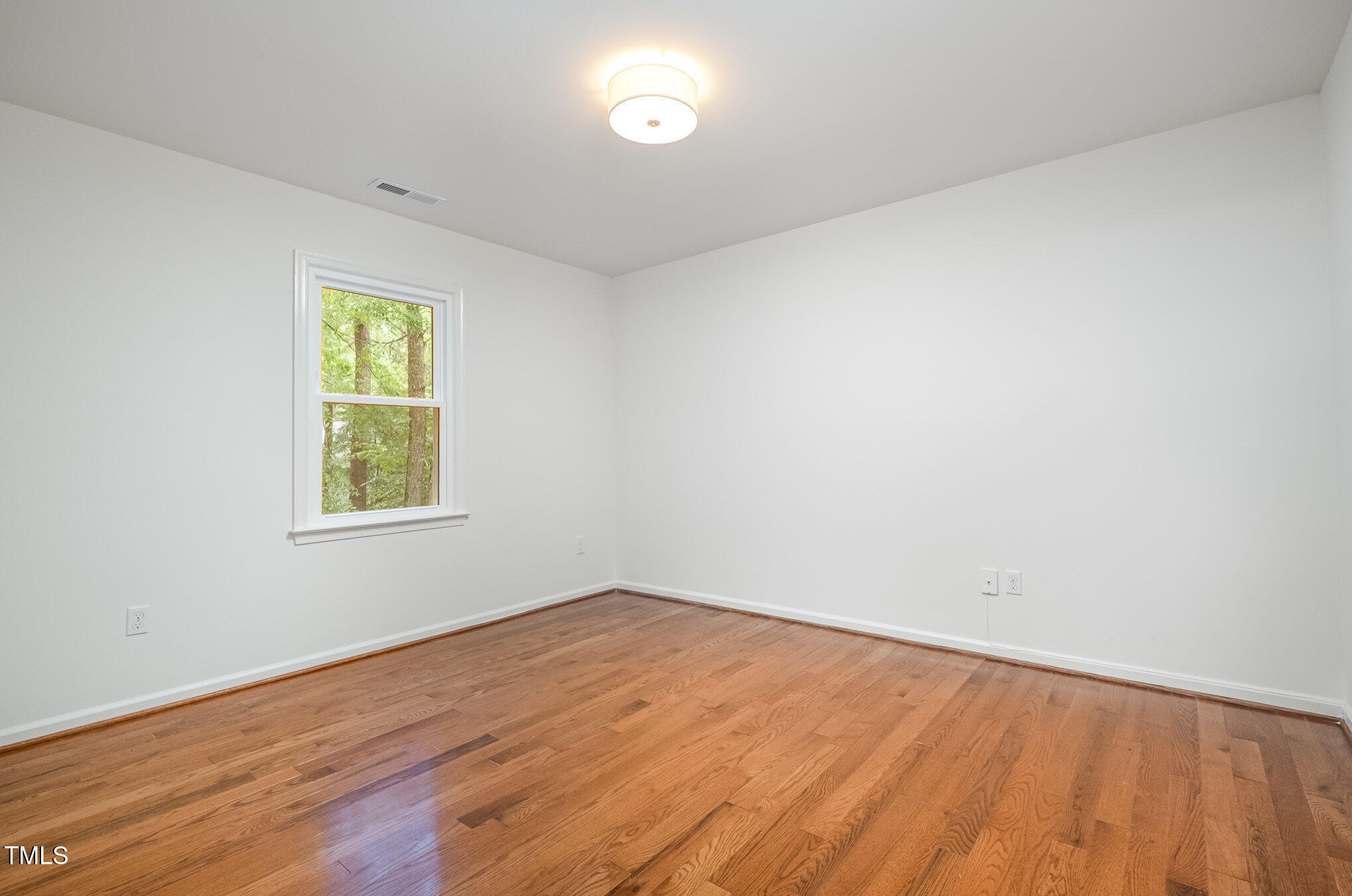 12 Striding Ridge Court Durham, NC 27713 - Photo 20 of 28 an empty room with wooden floor and windows